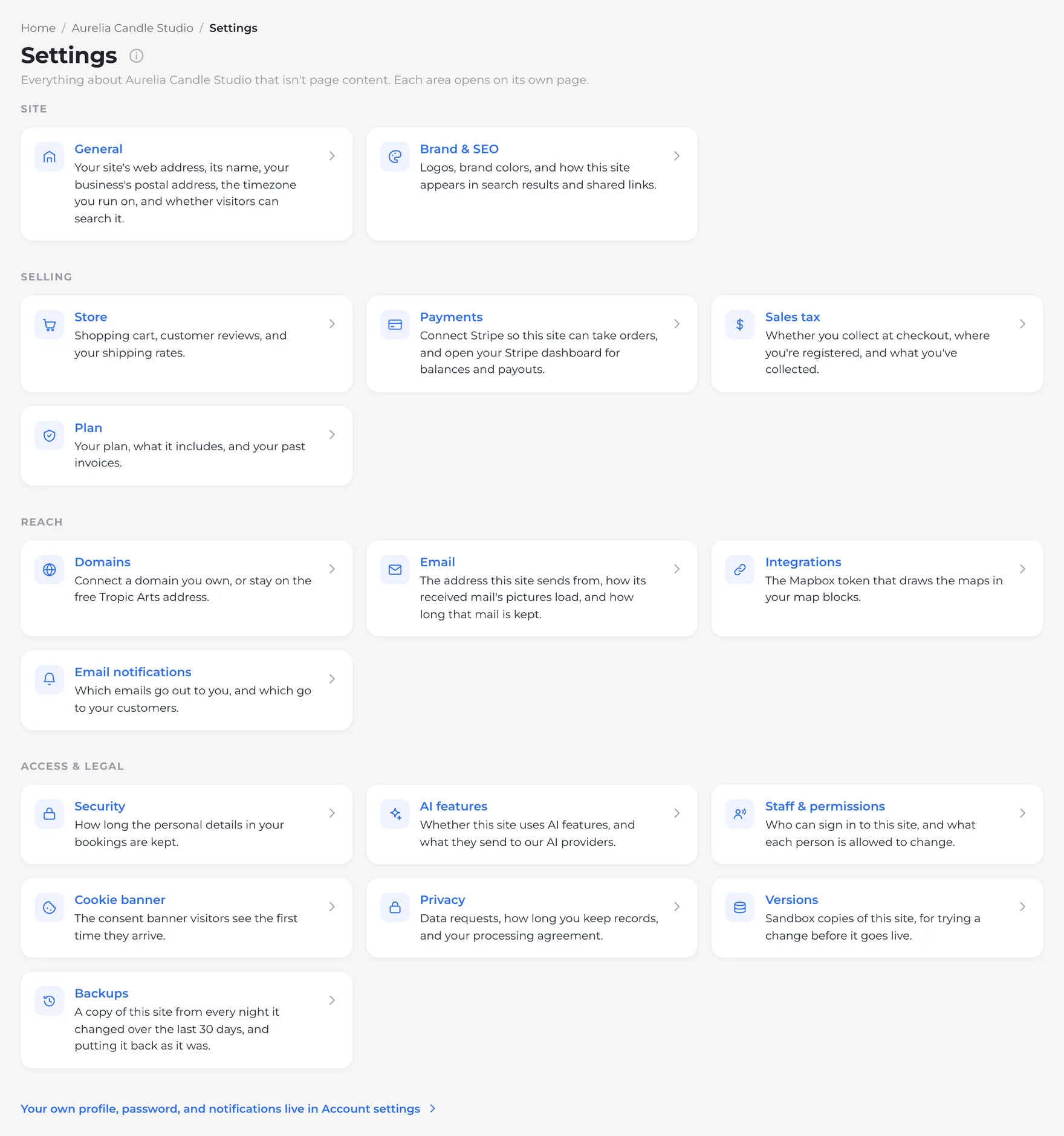 The Settings index for Aurelia Candle Studio in four groups: Site (General, Brand & SEO), Selling (Store, Payments, Sales tax, Plan), Reach (Domains, Email, Integrations, Email notifications), and Access & legal (Security, AI features, Staff & permissions, Cookie banner, Privacy, Versions, Backups). Each card says what's behind it, and a link to Account settings sits at the foot.